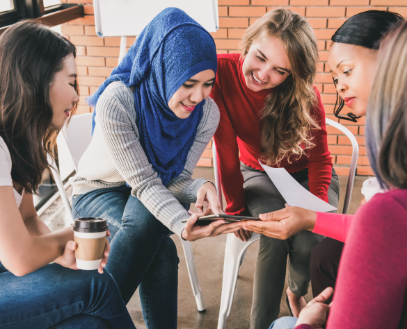 A Group of women discussing an item