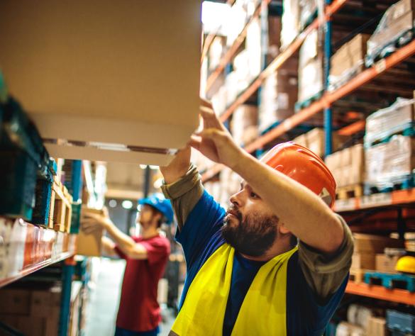 Close up of a warehouse workers carrying boxes