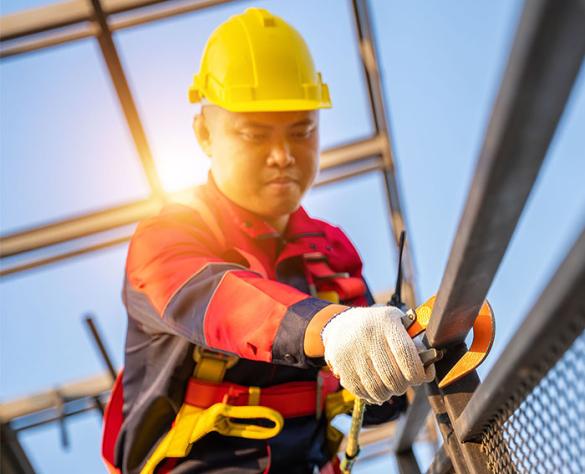 Man getting ready to work at heights in safety equipment